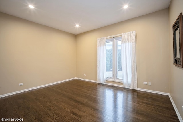 spare room featuring dark hardwood / wood-style floors