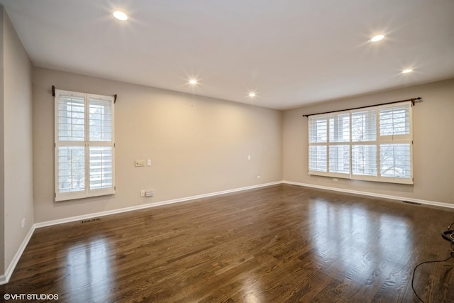 spare room featuring dark hardwood / wood-style floors