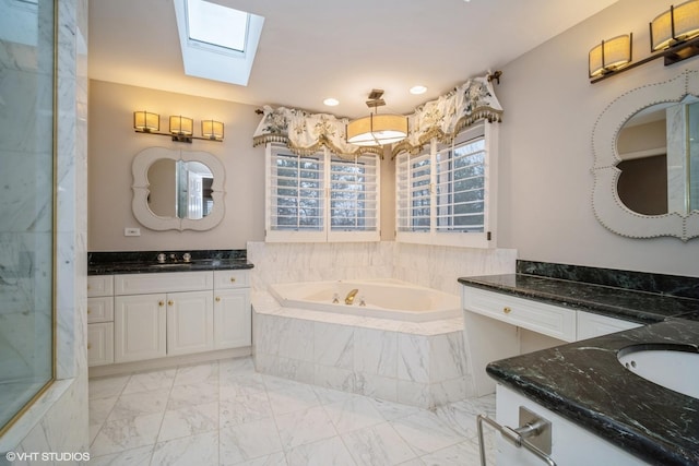 bathroom with vanity and independent shower and bath