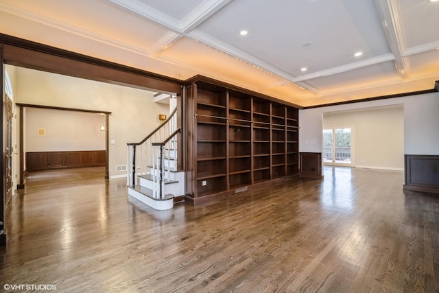 empty room with hardwood / wood-style flooring, coffered ceiling, beam ceiling, and crown molding