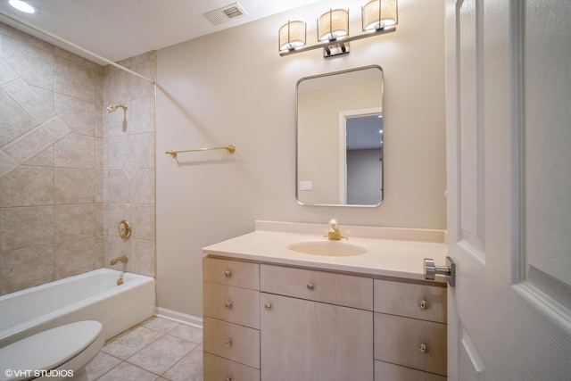 full bathroom featuring vanity, toilet, tiled shower / bath combo, and tile patterned flooring