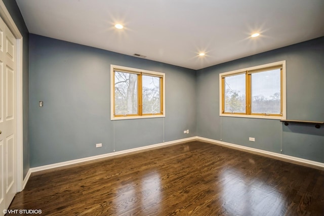 unfurnished room with dark hardwood / wood-style flooring