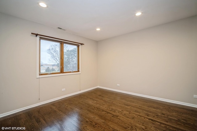 unfurnished room with dark wood-type flooring