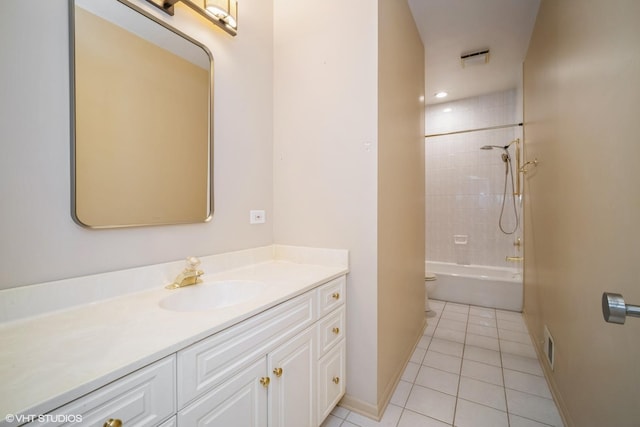 full bathroom featuring vanity, toilet, tiled shower / bath combo, and tile patterned flooring