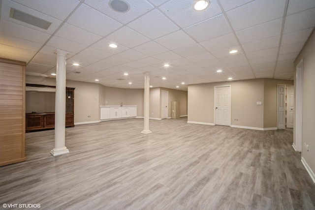 basement with wood-type flooring and a drop ceiling