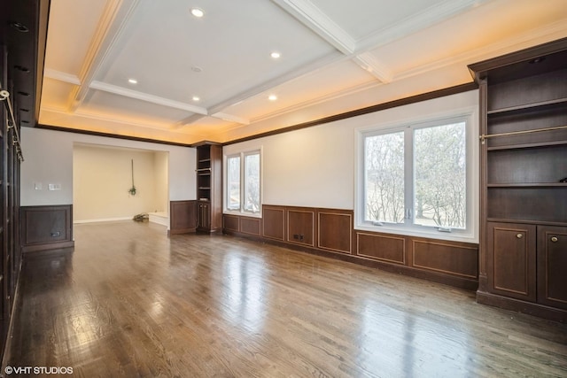 unfurnished living room with coffered ceiling, hardwood / wood-style flooring, built in shelves, and beamed ceiling