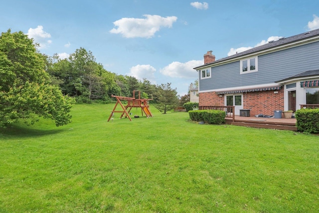 view of yard featuring a playground and a deck