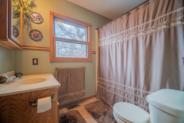 bathroom with tile patterned floors, vanity, toilet, and a shower with curtain