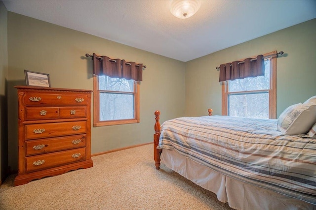 bedroom with light colored carpet and multiple windows