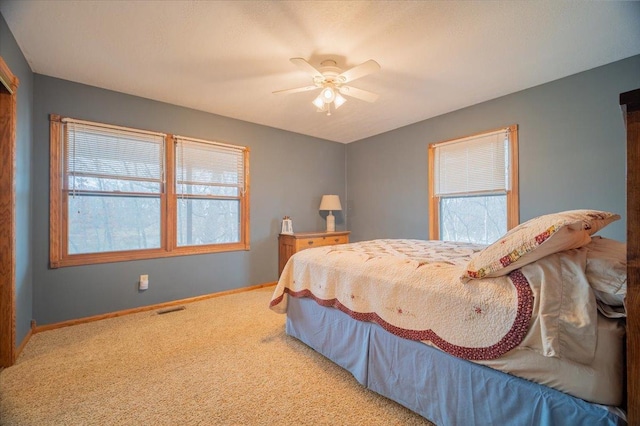 carpeted bedroom with ceiling fan