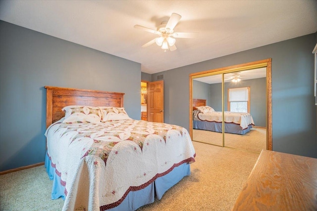 bedroom featuring ceiling fan, a closet, and carpet