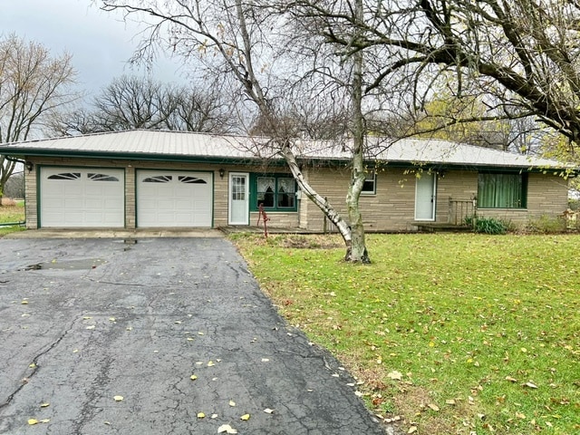 ranch-style house with a front yard and a garage