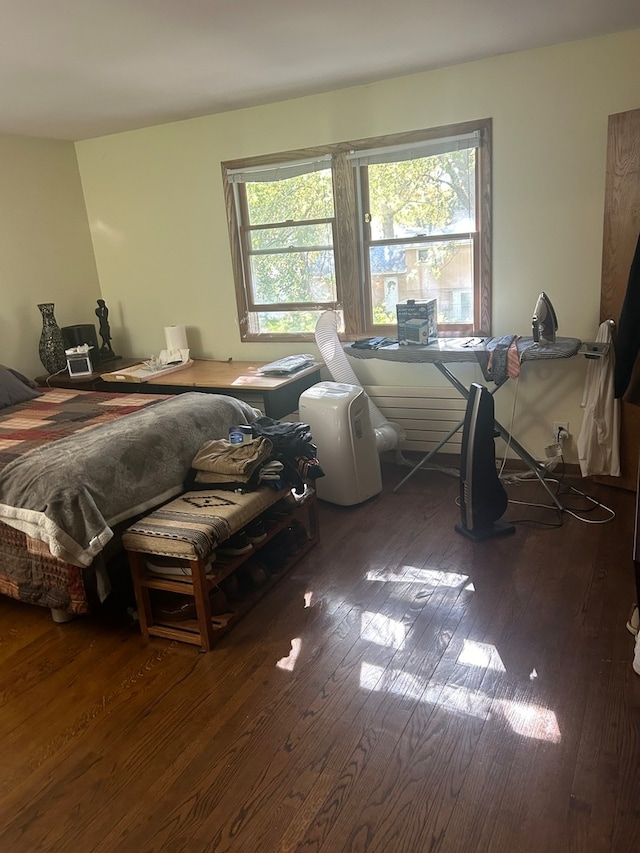 bedroom featuring dark hardwood / wood-style flooring