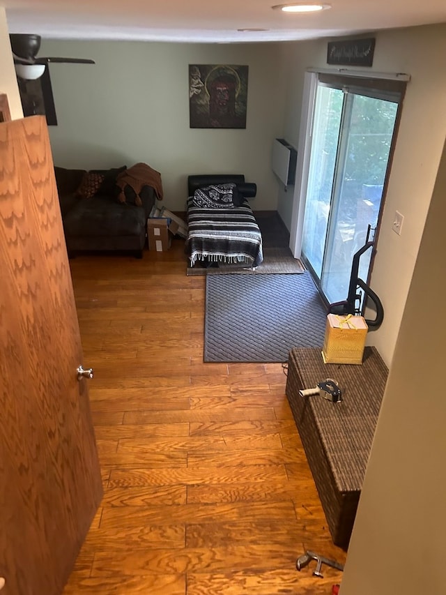 living room featuring ceiling fan and wood-type flooring