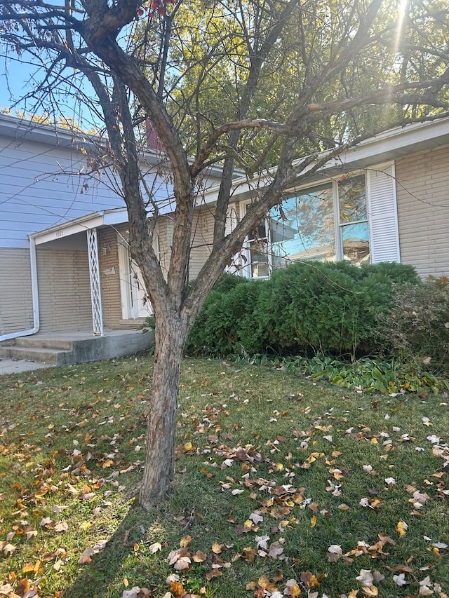 view of property exterior with a lawn