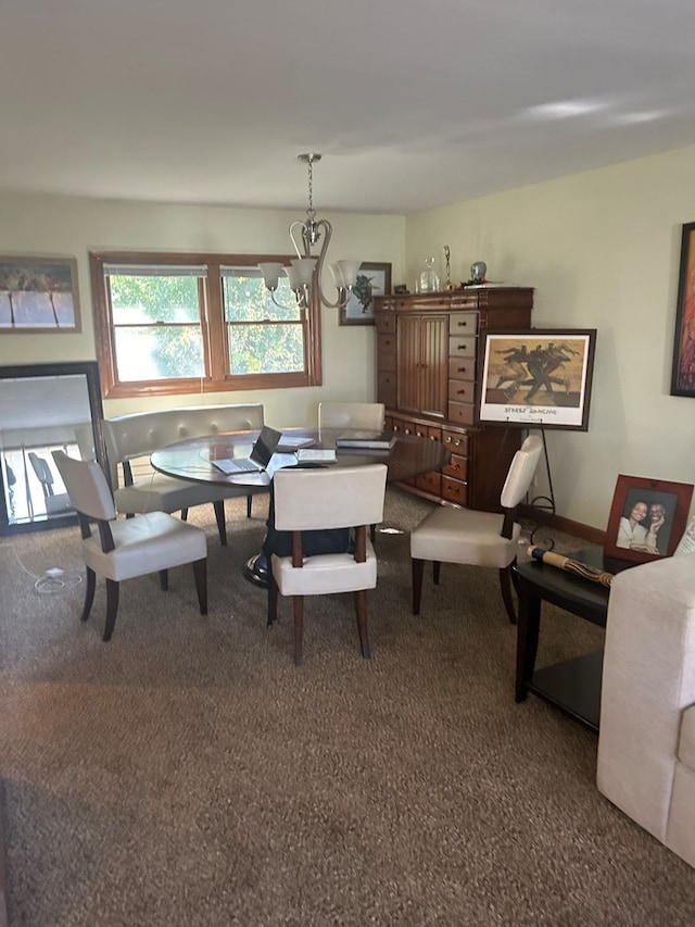 dining room with carpet floors and a chandelier