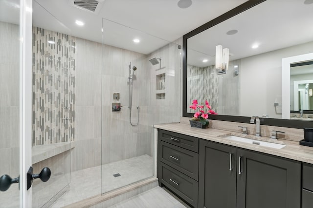 bathroom featuring tile walls, vanity, and tiled shower