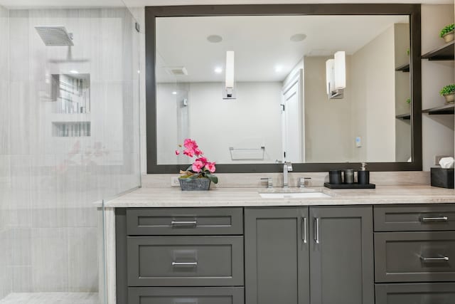 bathroom with vanity and a shower