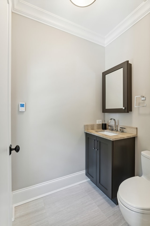 bathroom featuring vanity, toilet, and ornamental molding