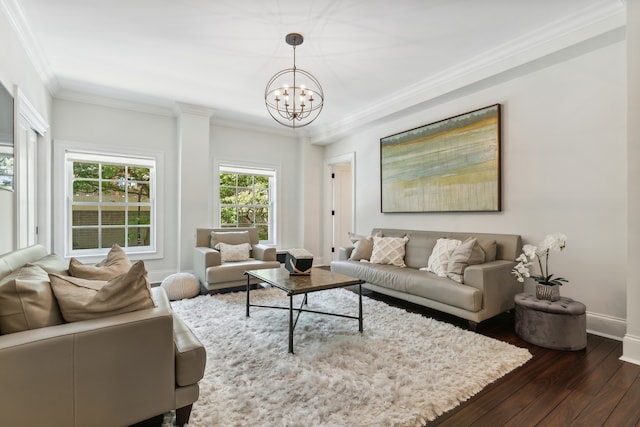 living room with crown molding, a notable chandelier, and dark hardwood / wood-style floors