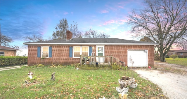 single story home featuring a yard and a garage