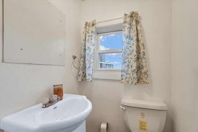 half bath with toilet and a sink