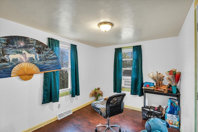 office with visible vents, plenty of natural light, baseboards, and wood finished floors