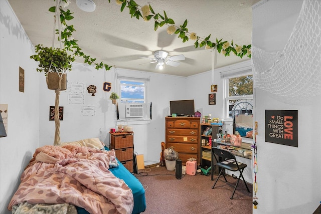 bedroom featuring carpet flooring, cooling unit, a textured ceiling, and ceiling fan