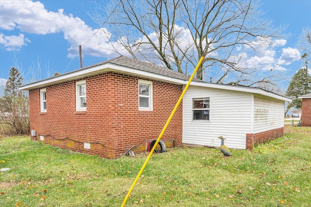 view of property exterior with brick siding, crawl space, and a yard