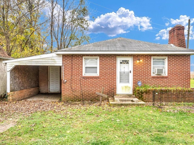 view of front of house with cooling unit, brick siding, a chimney, and a front lawn