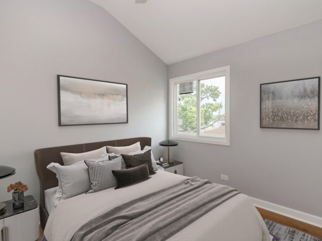 bedroom featuring hardwood / wood-style flooring and lofted ceiling