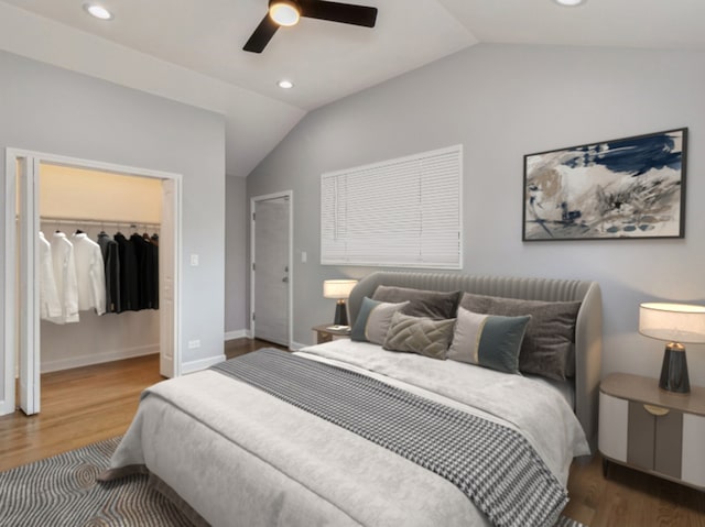 bedroom featuring hardwood / wood-style floors, vaulted ceiling, and ceiling fan