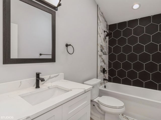 full bathroom with toilet, tiled shower / bath, and vanity