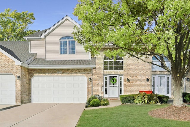 view of front of house with a front yard and a garage