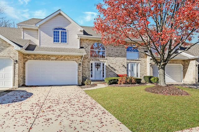 view of front facade with a front yard and a garage