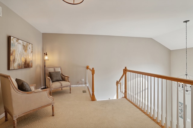 sitting room featuring carpet floors and lofted ceiling