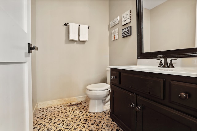 bathroom with tile patterned flooring, vanity, and toilet