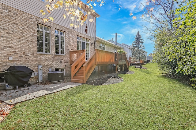 view of yard with central AC unit and a wooden deck