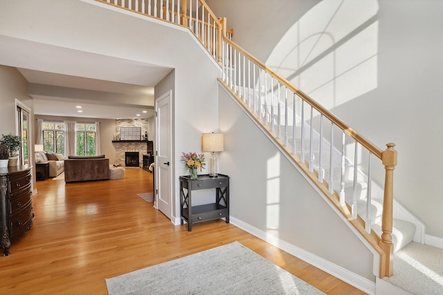 stairs featuring a fireplace and wood-type flooring