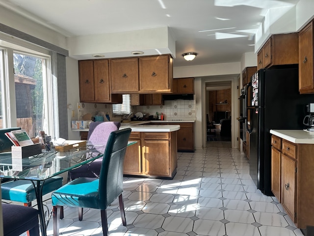 kitchen featuring tasteful backsplash and black appliances