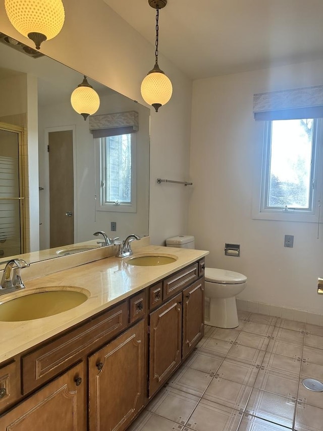 bathroom featuring walk in shower, vanity, and toilet