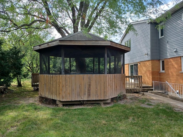 exterior space featuring a lawn and a sunroom