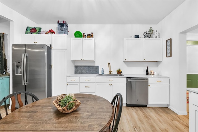 kitchen featuring light hardwood / wood-style flooring, white cabinets, stainless steel appliances, and sink