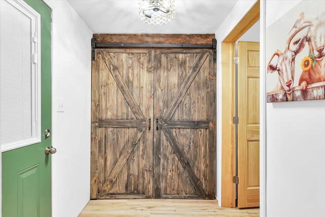 interior space featuring a barn door and light hardwood / wood-style floors