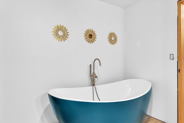 bathroom featuring a tub and hardwood / wood-style flooring