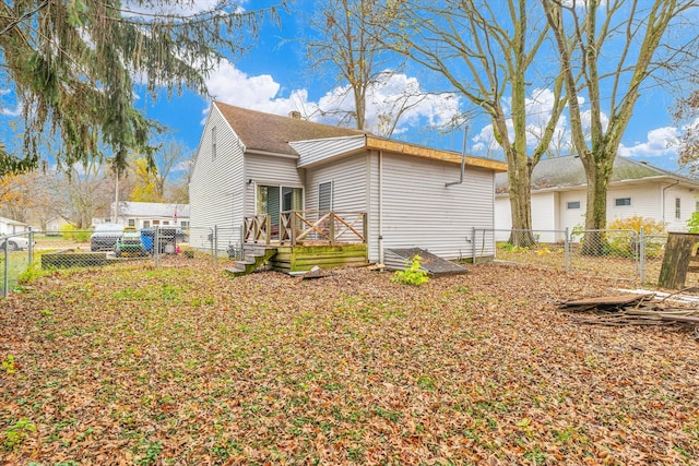 back of property featuring a wooden deck