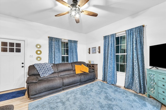 living room featuring ceiling fan and light wood-type flooring