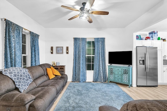 living room with ceiling fan and light wood-type flooring