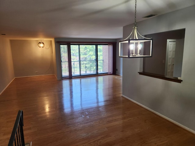 709 79th St Unit 309, Darien, IL 60561 - unfurnished dining area with a chandelier, baseboards, and wood finished floors