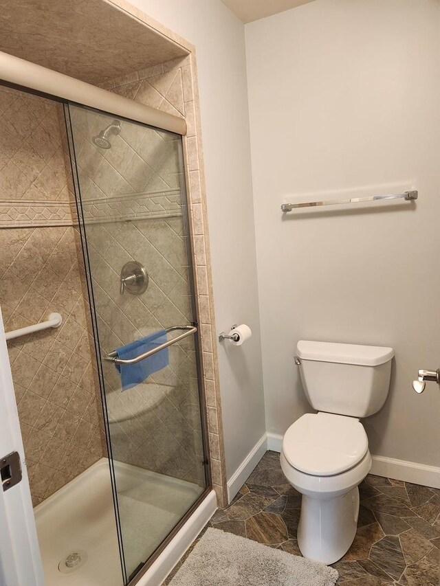 709 79th St Unit 309, Darien, IL 60561 - full bath with a shower stall, toilet, and baseboards